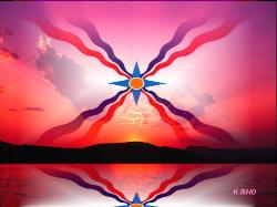 Assyrian flag at sunset at the far side of a lake and a mountain range